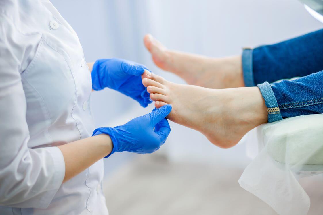 Dermatologist examines white toenails